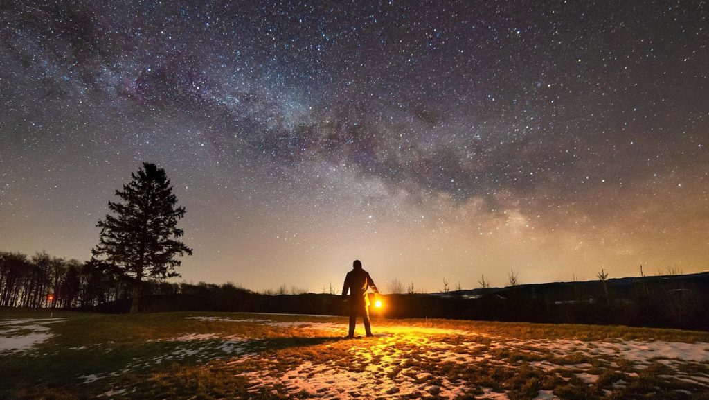 Mann mit Laterne unter dem Abendhimmel